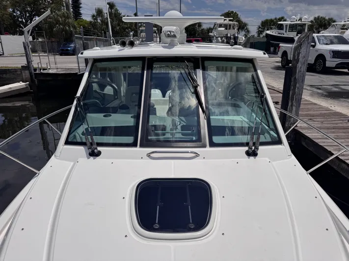  Yacht Photos Pics 2015 Boston Whaler 345 Conquest boat docked, front view with windshield and hatch.