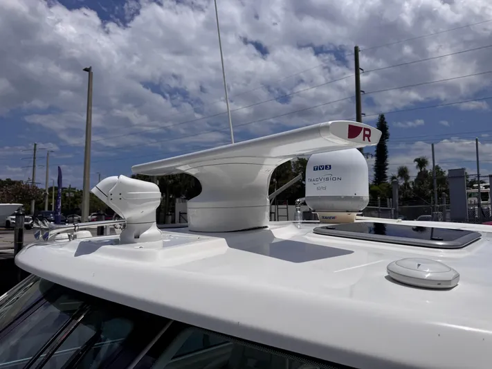  Yacht Photos Pics Radar equipment on 2015 Boston Whaler 345 Conquest under a partly cloudy sky.