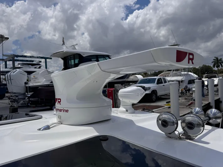  Yacht Photos Pics 2015 Boston Whaler 345 Conquest radar system at marina, cloudy sky background.
