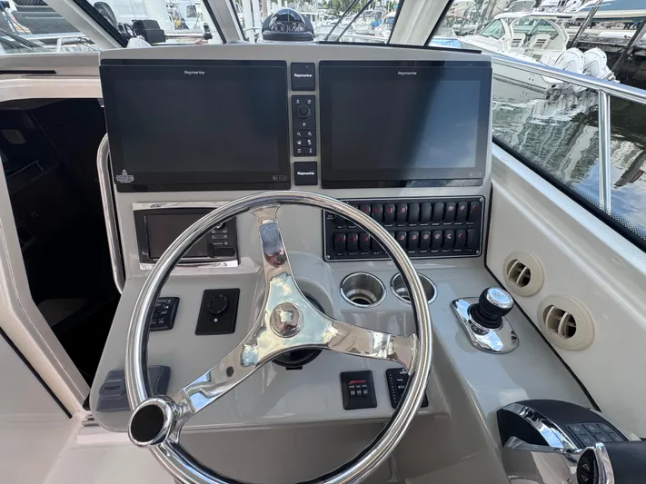  Yacht Photos Pics 2015 Boston Whaler 345 Conquest helm with dual screens and steering wheel.