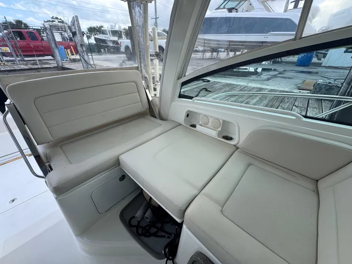  Yacht Photos Pics 2015 Boston Whaler 345 Conquest interior seating area with beige upholstery.