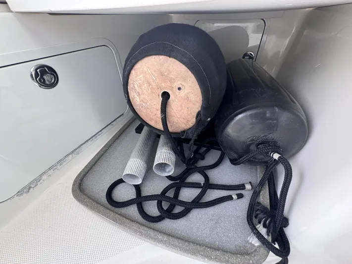  Yacht Photos Pics Storage compartment on a 2015 Boston Whaler 345 Conquest with boat fenders and ropes.