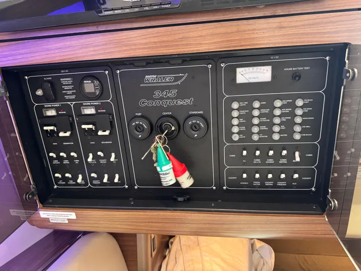  Yacht Photos Pics Control panel of a 2015 Boston Whaler 345 Conquest boat with switches and keys.