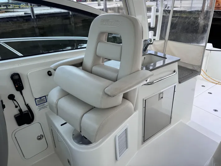  Yacht Photos Pics Captain's chair on 2015 Boston Whaler 345 Conquest boat, featuring sleek design and controls.