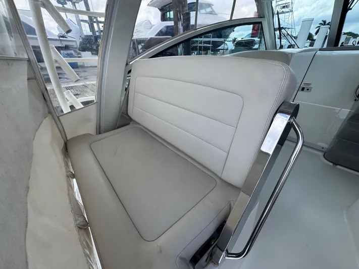  Yacht Photos Pics Interior seating of 2015 Boston Whaler 345 Conquest boat, featuring cushioned bench.
