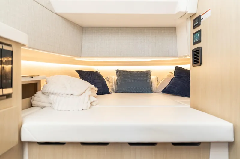 Let&rsquo;s Go Yacht Photos Pics Luxurious cabin interior of 2025 Regal 38 SAV yacht with cozy bedding and ambient lighting.