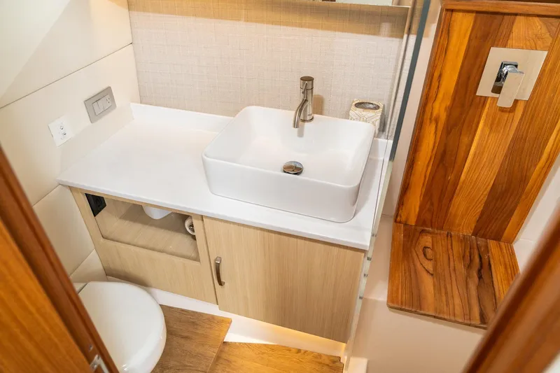Let&rsquo;s Go Yacht Photos Pics Luxurious bathroom interior of 2025 Regal 38 SAV yacht with modern sink and wooden accents.