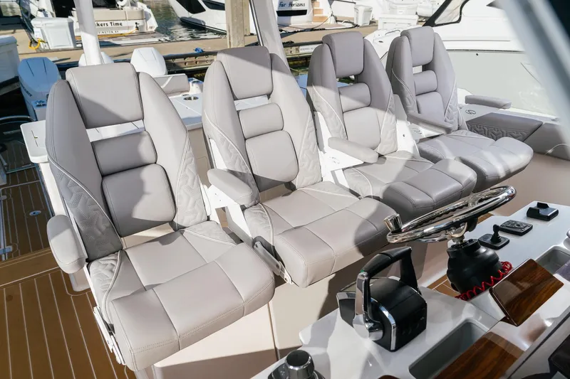 Let&rsquo;s Go Yacht Photos Pics Luxurious seating on 2025 Regal 38 SAV boat, featuring modern helm controls.