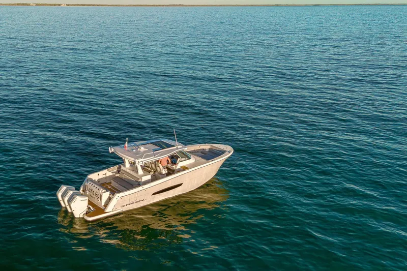 Let&rsquo;s Go Yacht Photos Pics 2025 Regal 38 SAV boat cruising on open water under clear skies.