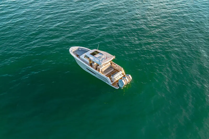 Let&rsquo;s Go Yacht Photos Pics Aerial view of 2025 Regal 38 SAV boat on calm ocean waters.