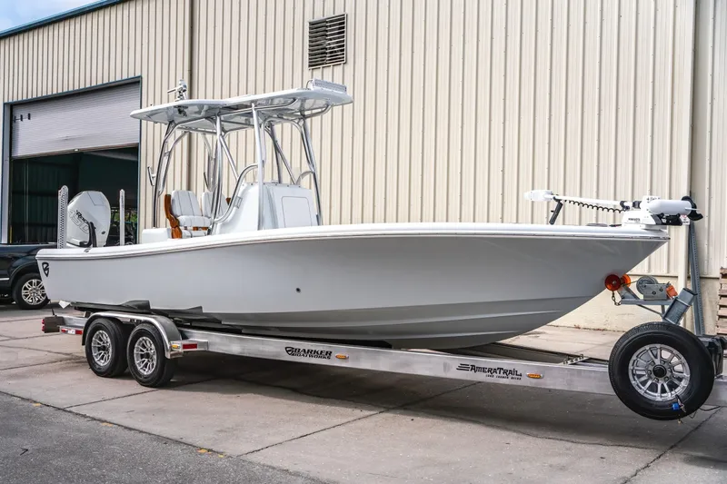  Yacht Photos Pics 2026 Barker Boatworks 26 Open on trailer, parked outside a warehouse.