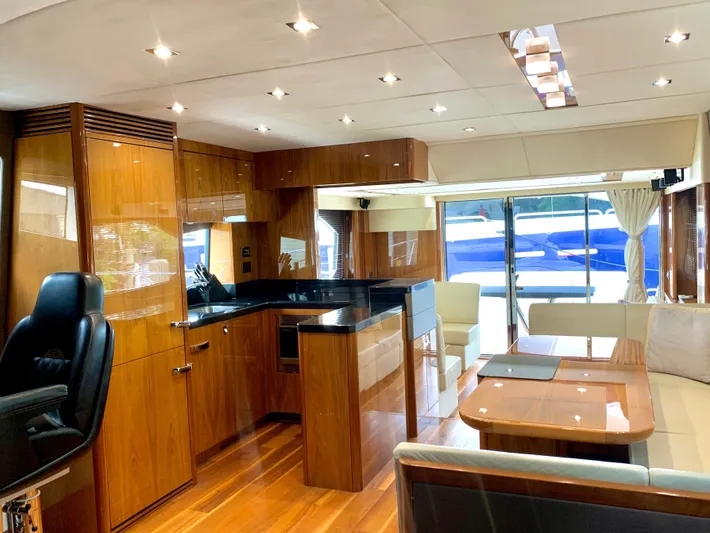  Yacht Photos Pics Luxurious interior of 2016 Sunseeker Manhattan 65 yacht with modern kitchen and dining area.