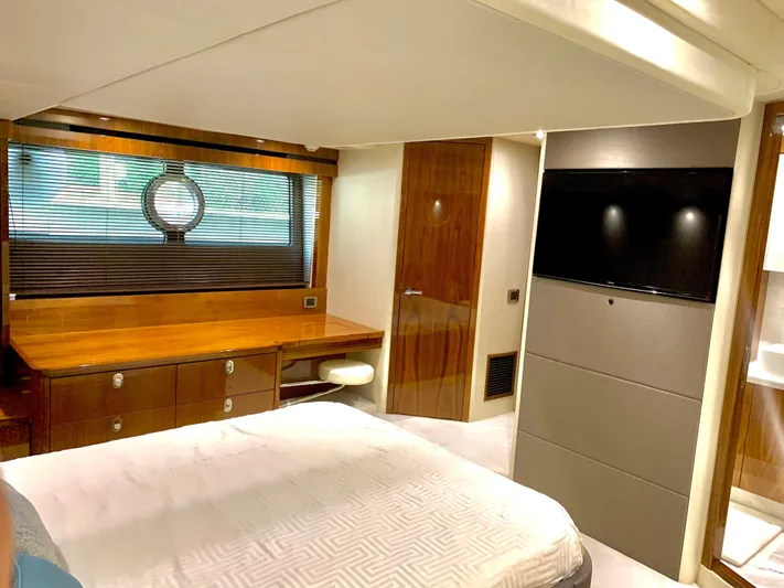  Yacht Photos Pics Luxurious bedroom interior of 2016 Sunseeker Manhattan 65 yacht with modern furnishings.
