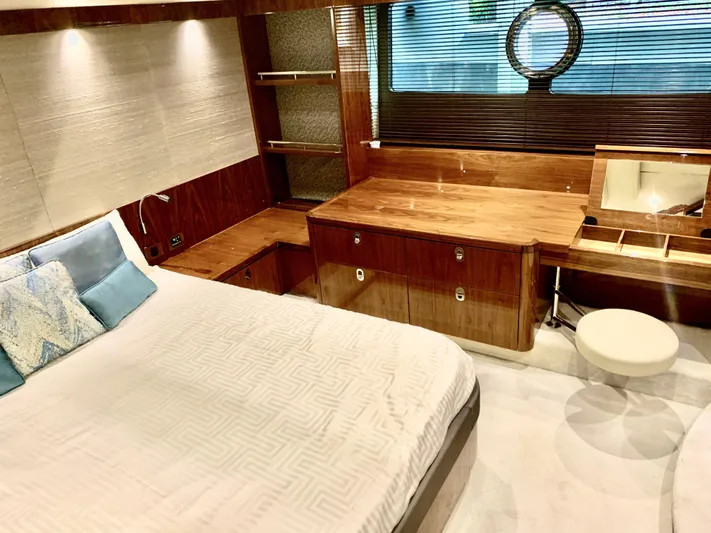  Yacht Photos Pics Luxurious bedroom interior of 2016 Sunseeker Manhattan 65 yacht with wooden furnishings.