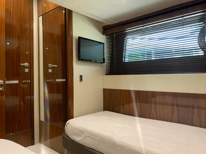  Yacht Photos Pics Luxurious cabin interior of 2016 Sunseeker Manhattan 65 yacht with twin beds and TV.