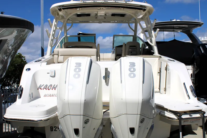  Yacht Photos Pics 2021 Boston Whaler 320 Vantage with twin 300 horsepower engines, docked under a clear sky.
