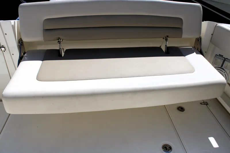  Yacht Photos Pics 2021 Boston Whaler 320 Vantage boat seat, featuring cushioned backrest and foldable design.