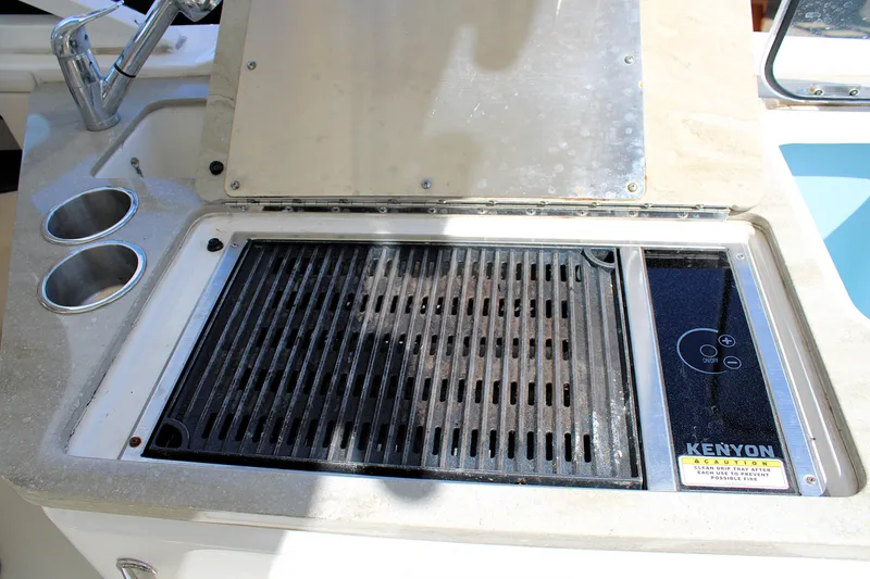  Yacht Photos Pics Outdoor grill on 2021 Boston Whaler 320 Vantage boat with dual cup holders.
