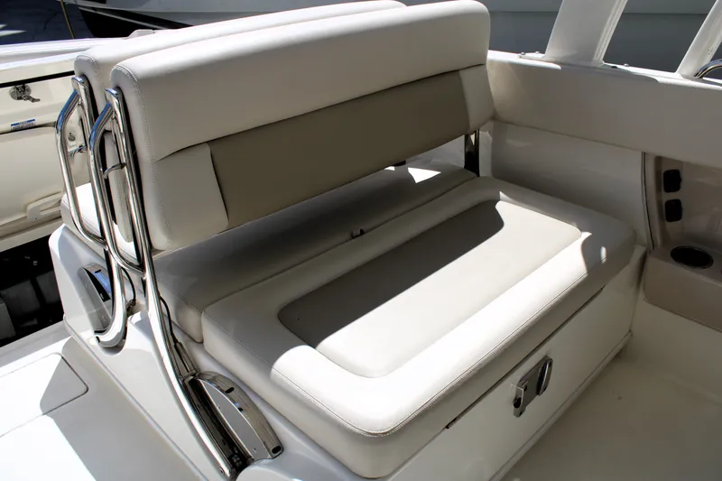  Yacht Photos Pics 2021 Boston Whaler 320 Vantage boat seating with beige cushions and stainless steel accents.
