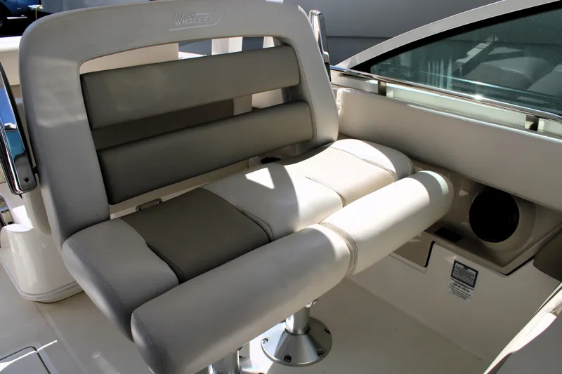  Yacht Photos Pics 2021 Boston Whaler 320 Vantage boat seat with beige upholstery and stainless steel accents.