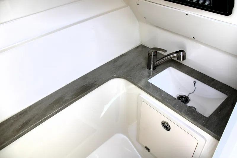  Yacht Photos Pics 2021 Boston Whaler 320 Vantage boat interior with sink and faucet.