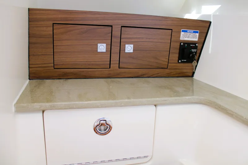  Yacht Photos Pics 2021 Boston Whaler 320 Vantage interior with wood paneling and control panel.