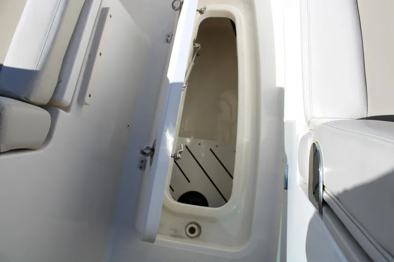  Yacht Photos Pics 2021 Boston Whaler 320 Vantage storage compartment with open hatch and seating.