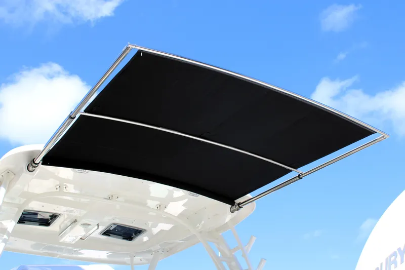  Yacht Photos Pics Boston Whaler 320 Vantage 2021 boat canopy against blue sky.