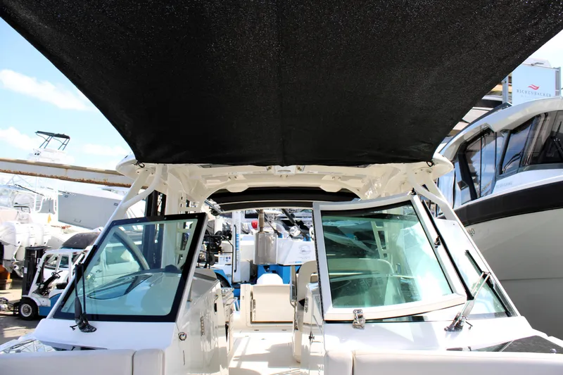  Yacht Photos Pics 2021 Boston Whaler 320 Vantage boat with black canopy and open cockpit view.