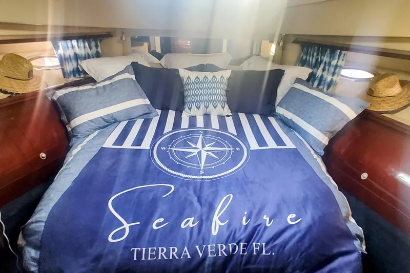  Yacht Photos Pics Luxurious 2007 Sea Ray 58 Sedan Bridge cabin with nautical-themed bedding.