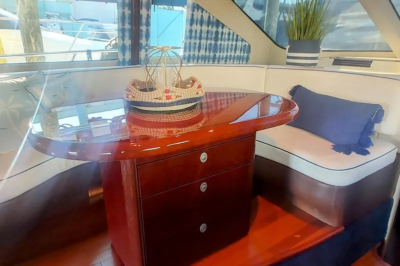  Yacht Photos Pics Luxurious interior of 2007 Sea Ray 58 Sedan Bridge with elegant wood table and seating.