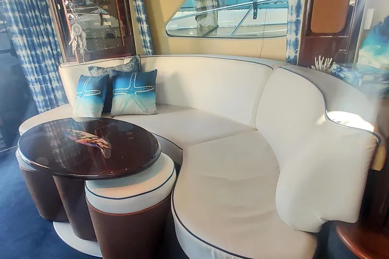  Yacht Photos Pics Luxurious interior of 2007 Sea Ray 58 Sedan Bridge with elegant seating and nautical decor.