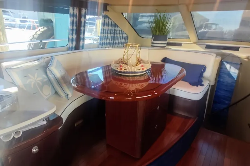  Yacht Photos Pics Luxurious interior of 2007 Sea Ray 58 Sedan Bridge yacht with elegant dining area.