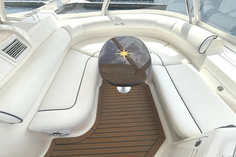  Yacht Photos Pics Luxurious interior of 2007 Sea Ray 58 Sedan Bridge with elegant seating and wooden table.