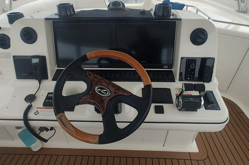  Yacht Photos Pics 2007 Sea Ray 58 Sedan Bridge helm with dual screens and wooden steering wheel.