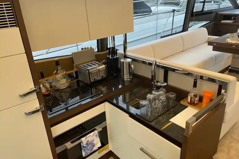  Yacht Photos Pics Luxurious kitchen area on a 2020 Prestige 520 yacht with modern appliances and seating.