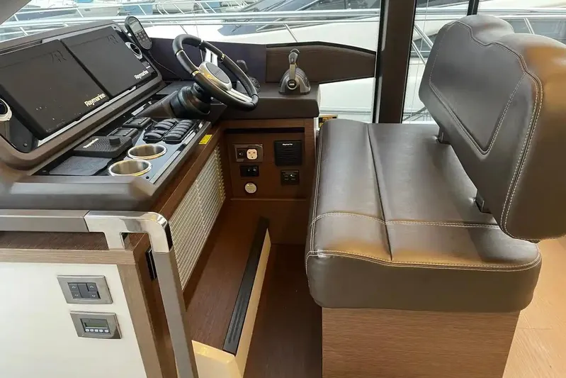 Yacht Photos Pics 2020 Prestige 520 yacht helm with leather seating and modern navigation controls.