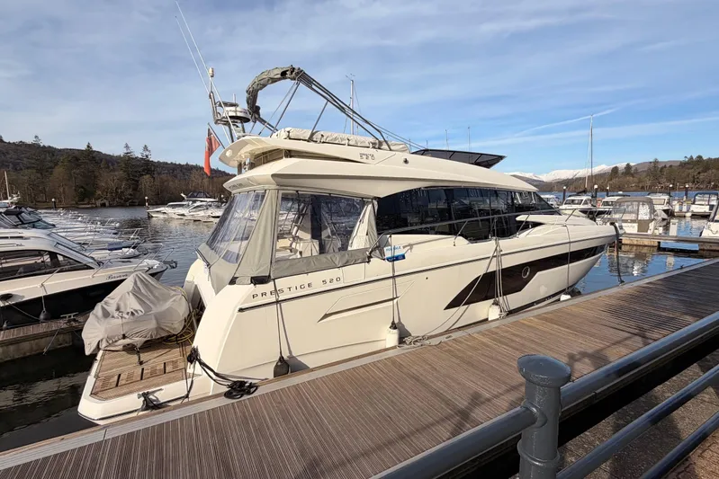  Yacht Photos Pics Luxury 2020 Prestige 520 yacht docked at marina with scenic background.