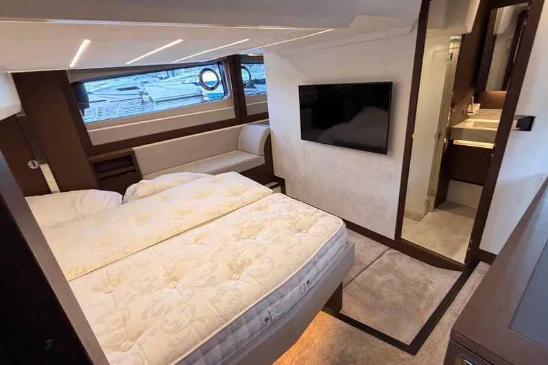  Yacht Photos Pics Luxurious interior of 2020 Prestige 520 yacht with bed, TV, and ensuite bathroom.