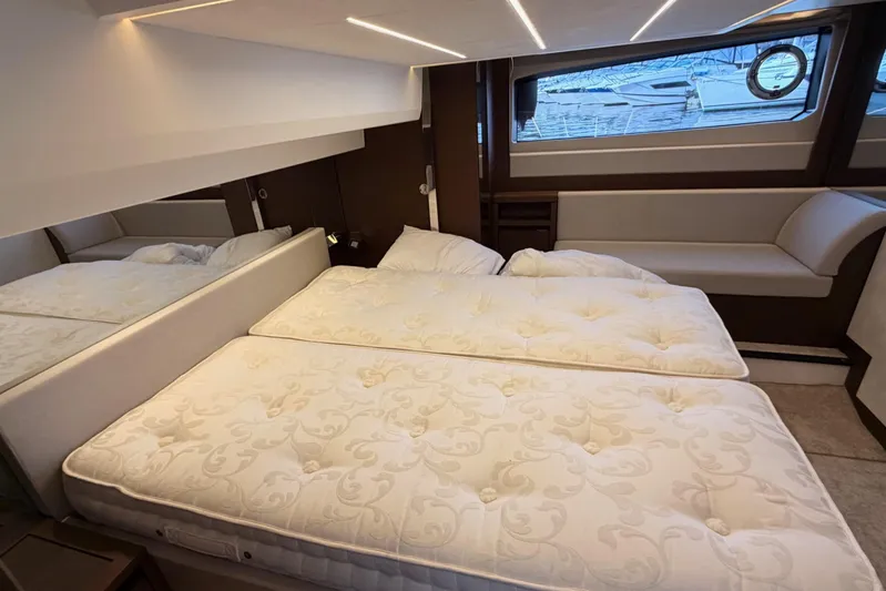  Yacht Photos Pics Luxurious cabin interior of 2020 Prestige 520 yacht with elegant bedding and seating.