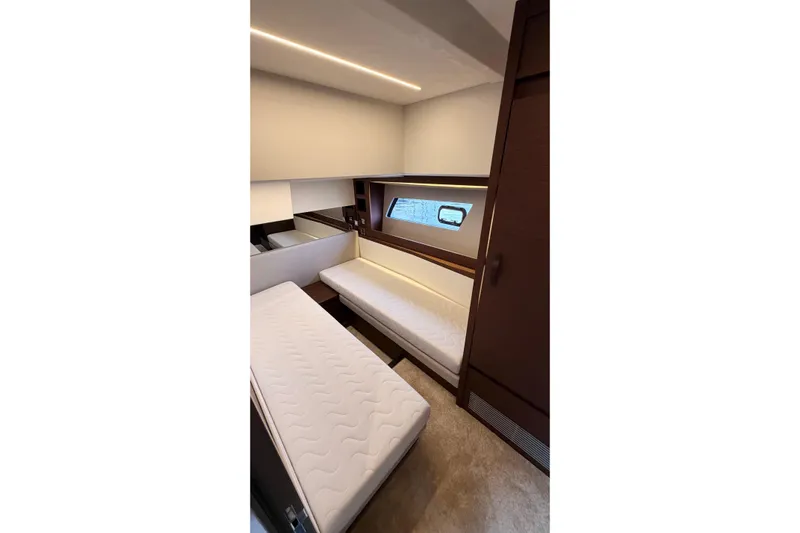  Yacht Photos Pics Interior of 2020 Prestige 520 yacht cabin with twin beds and window view.