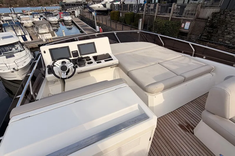  Yacht Photos Pics Flybridge of 2020 Prestige 520 yacht with helm, seating, and marina view.