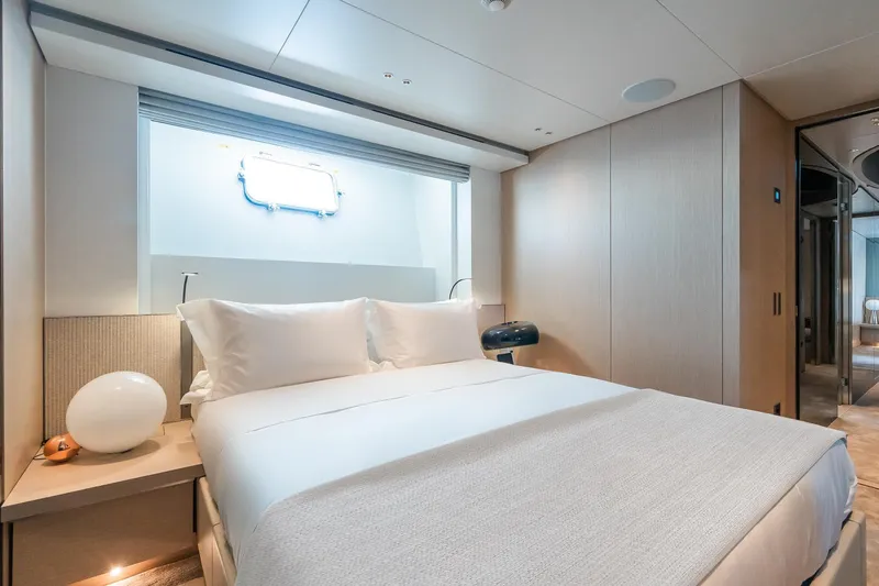 Ami Yacht Photos Pics Luxurious bedroom interior of 2023 Sanlorenzo SX112 yacht with modern design and cozy ambiance.