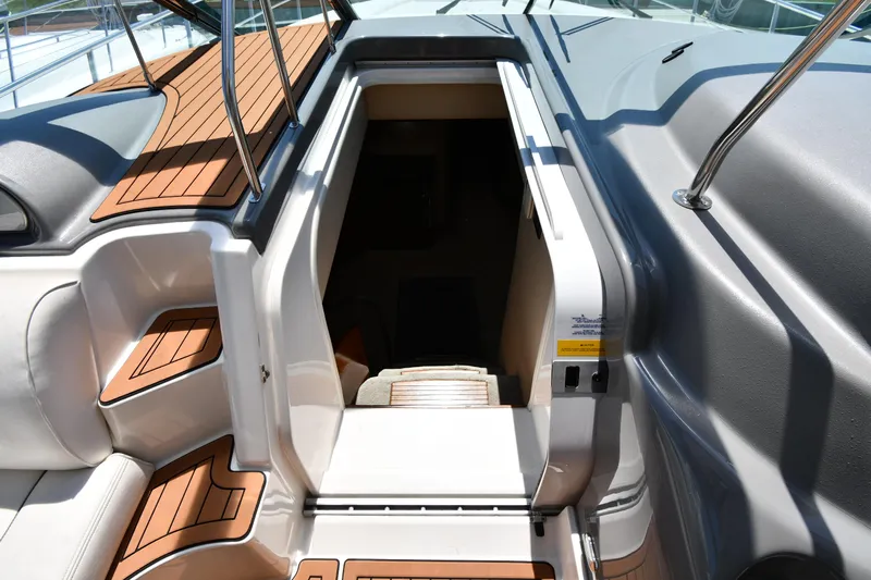 This Is It Yacht Photos Pics 2005 Cruisers Yachts 520 Express cabin entrance with teak steps and seating.