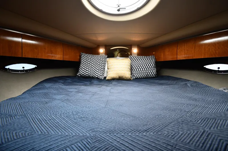 This Is It Yacht Photos Pics Luxurious cabin interior of 2005 Cruisers Yachts 520 Express with cozy bedding.