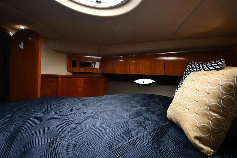 This Is It Yacht Photos Pics Luxurious cabin interior of 2005 Cruisers Yachts 520 Express with plush bedding.