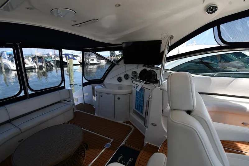 This Is It Yacht Photos Pics Interior of 2005 Cruisers Yachts 520 Express with seating and helm station.