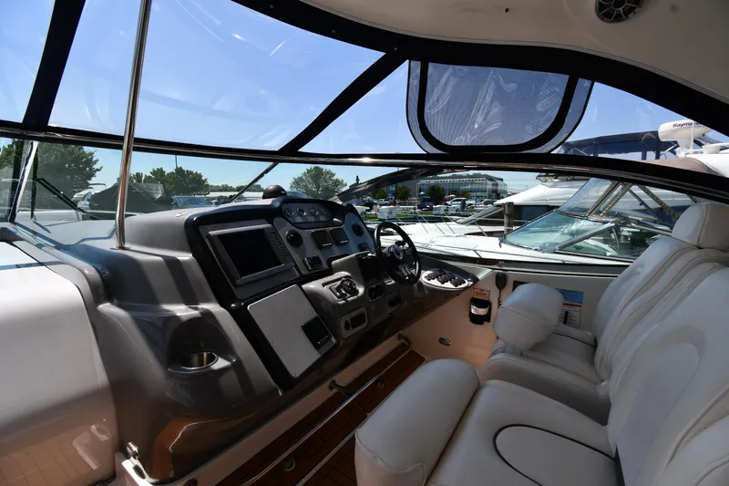 This Is It Yacht Photos Pics 2005 Cruisers Yachts 520 Express helm with modern controls and comfortable seating.