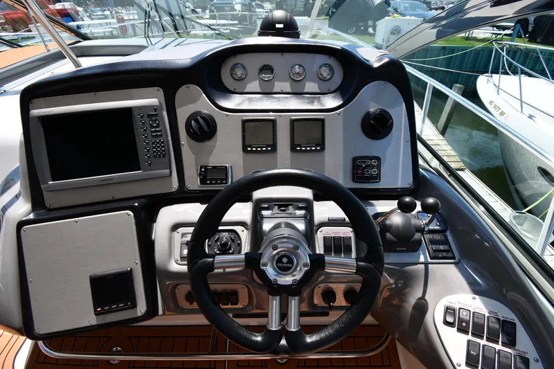 This Is It Yacht Photos Pics Helm of 2005 Cruisers Yachts 520 Express with advanced navigation controls.
