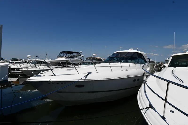 This Is It Yacht Photos Pics 2005 Cruisers Yachts 520 Express docked at a marina on a sunny day.
